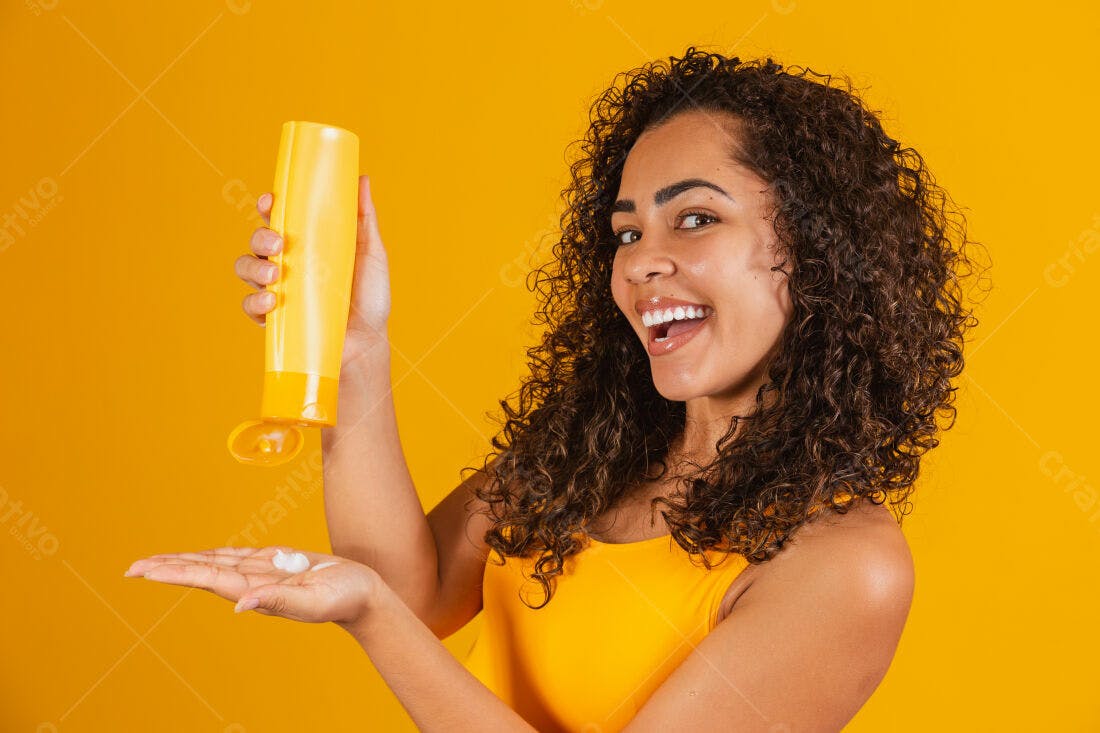Mulher feliz aplicando protetor solar amarelo