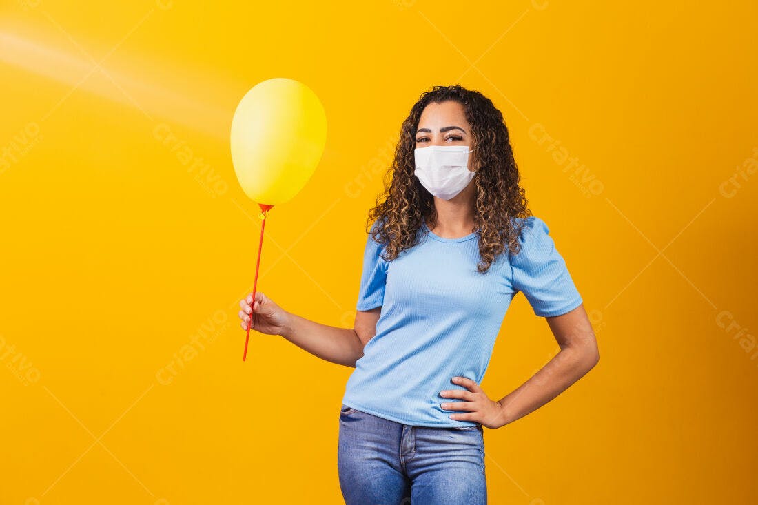 Mulher com máscara segurando balão amarelo
