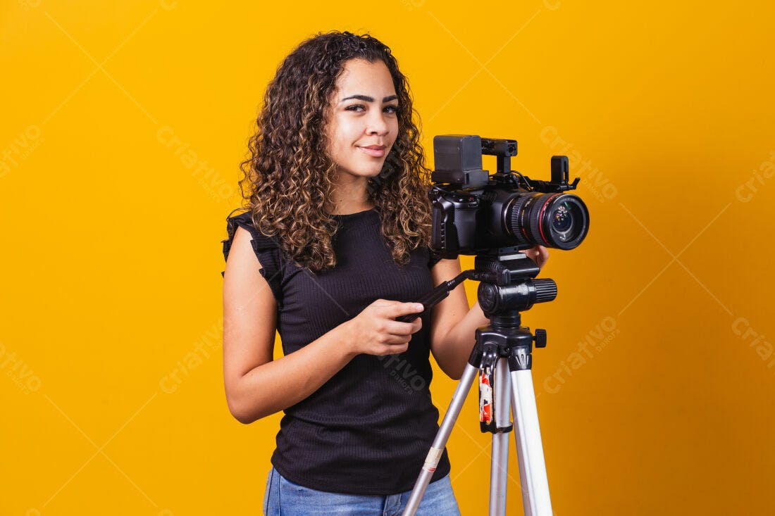 Mulher com câmera profissional em fundo amarelo