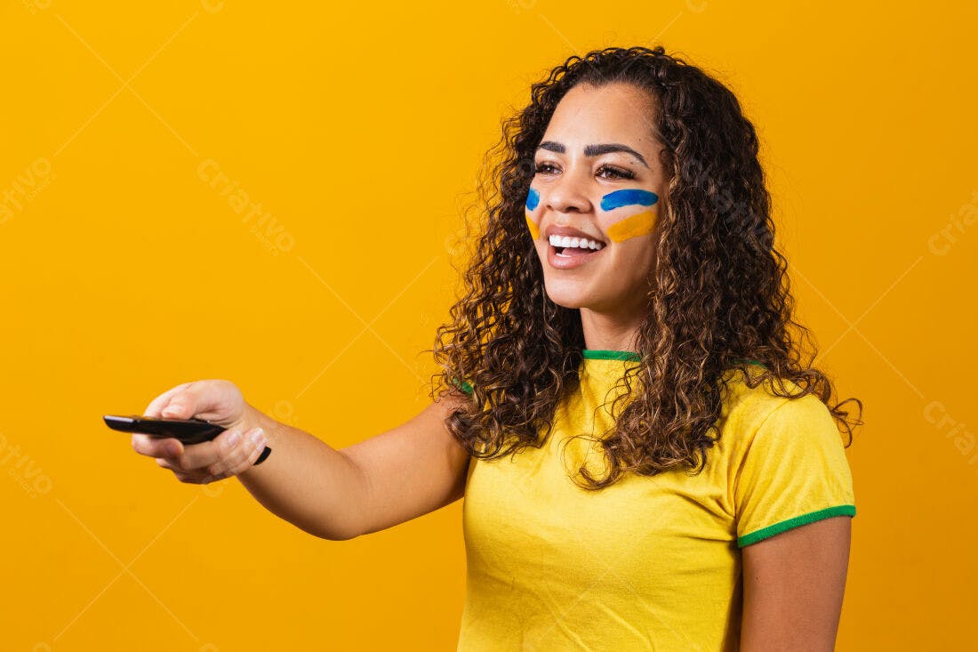 Mulher torcedora usando controle remoto fundo amarelo