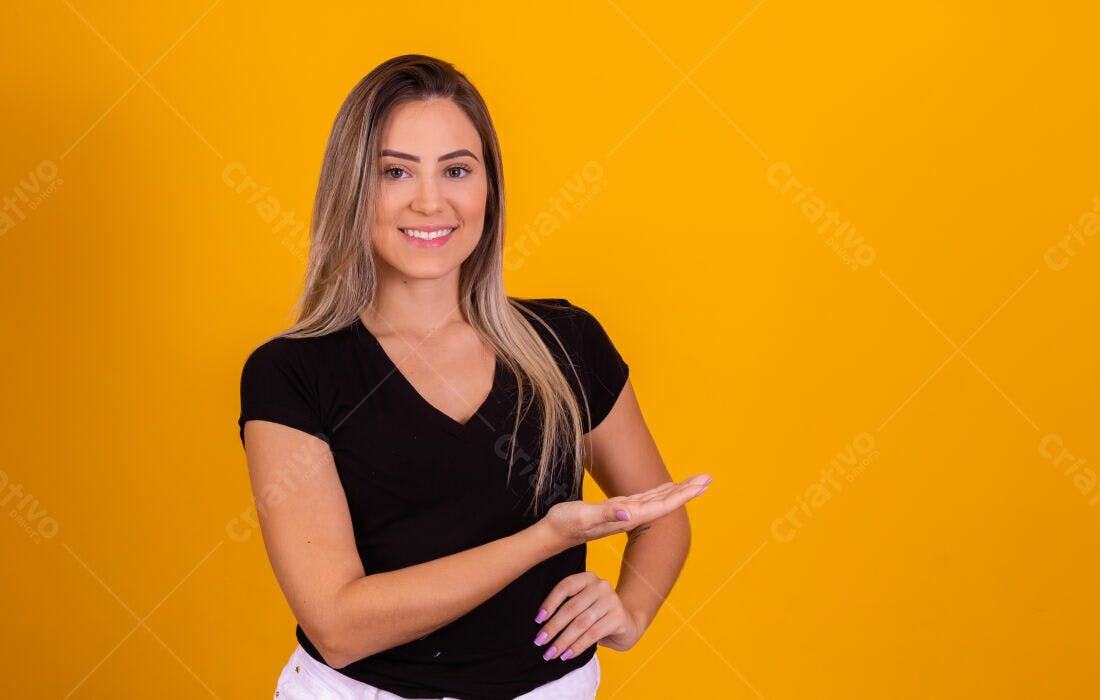 Mulher sorridente mostrando produto fundo amarelo