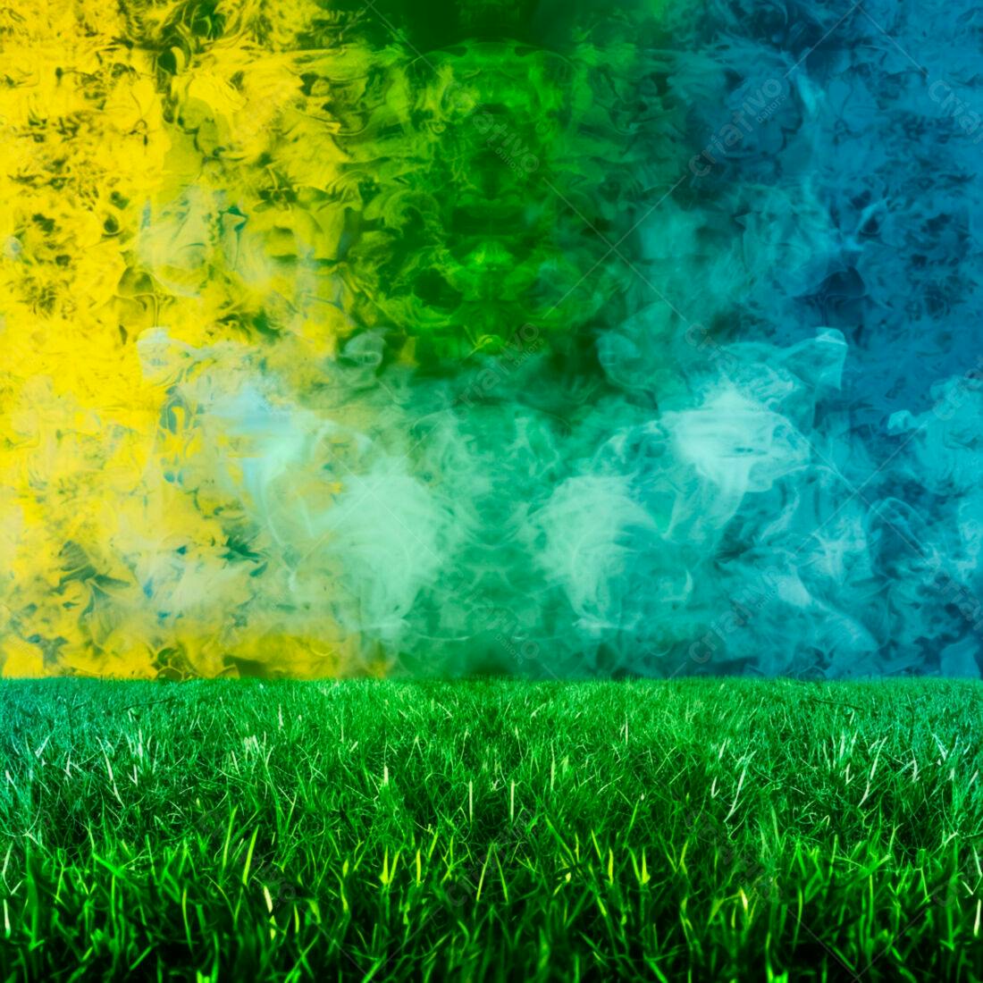 Campo de grama verde com fumaça amarela azul e verde
