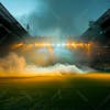 Modernized football stadium filled with smoke and illuminated by lights