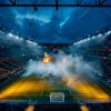 Modernized soccer stadium filled with smoke and illuminated by lights