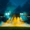 Modernized soccer stadium full of smoke and illuminated by lights