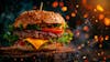 Complete hamburger, on top of a board with sparkling background