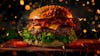 Complete burger, on a cutting board with sparkling background