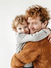 Father's day image, affection hug between father and son, white isolated background