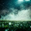 Soccer field at night with fog and dust.