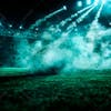 Football field at night with fog and dust