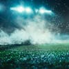 Football field at night with fog and dust.