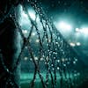 Close up of a soccer goal post at night.