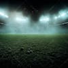 Soccer field shrouded in fog and dust particles.