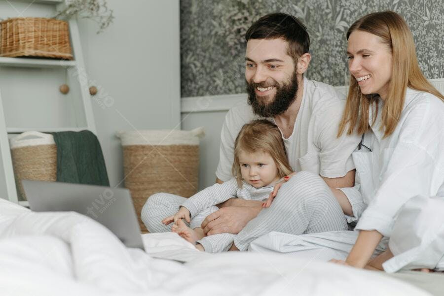 Família assistindo vídeo na cama