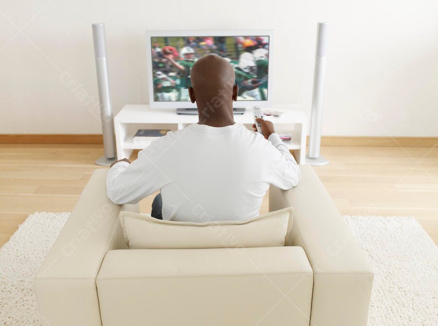 Homem assistindo jogo de futebol na TV