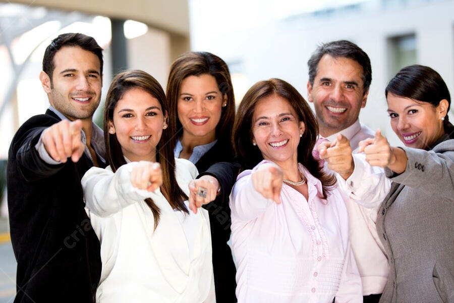 Equipe de negócios apontando para você