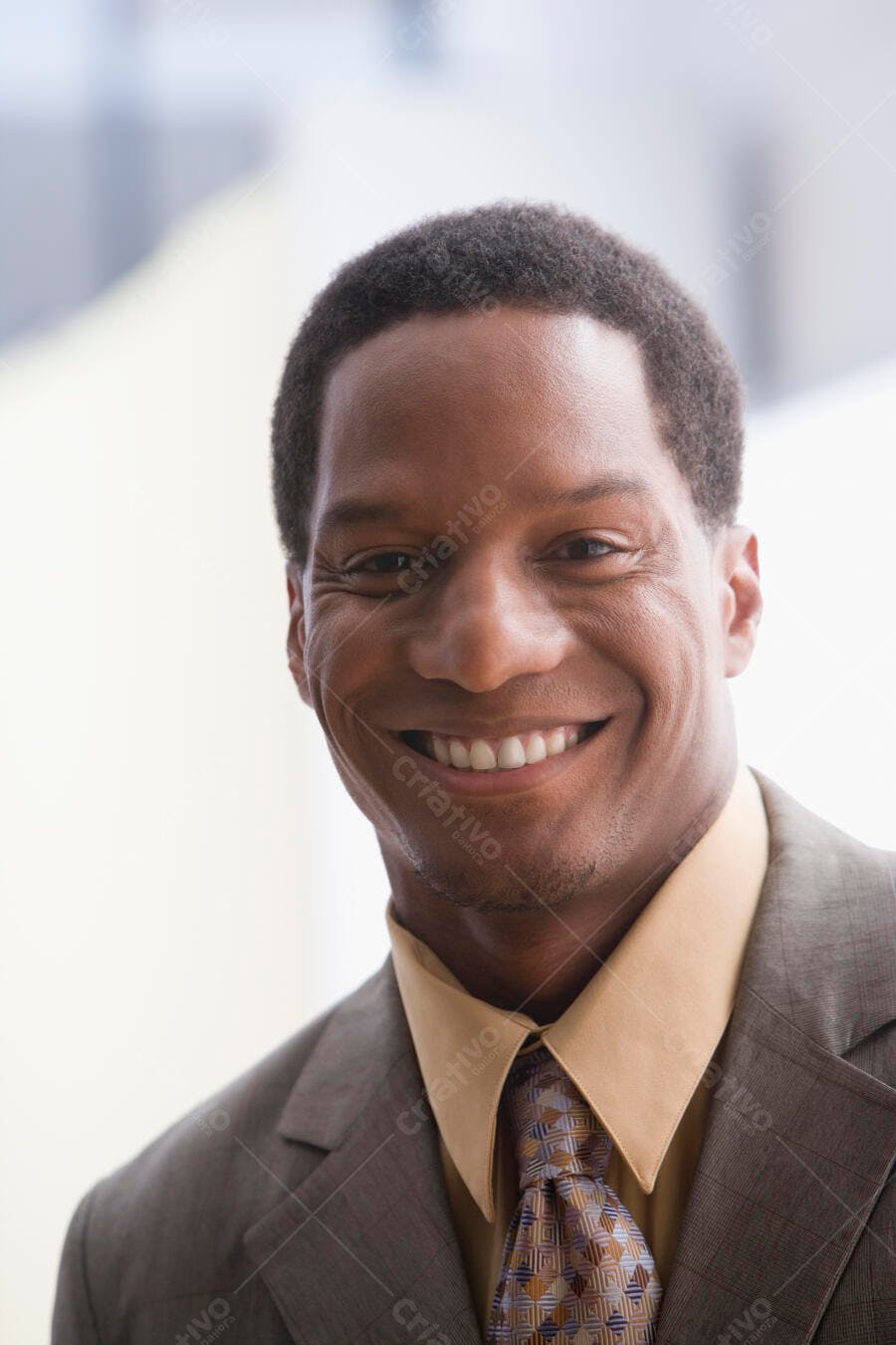Homem negro sorridente em terno cinza