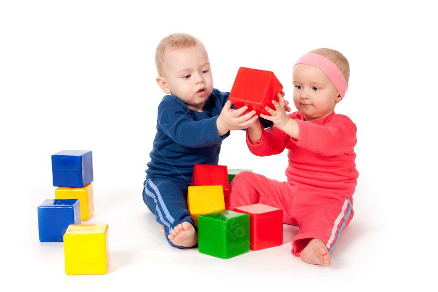 Bebês brincando com blocos coloridos