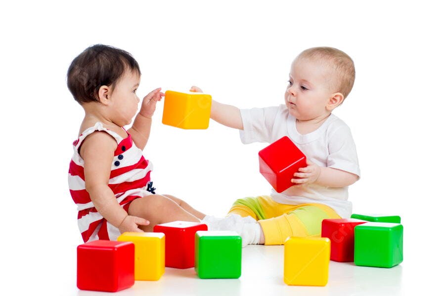 Bebês brincando com blocos coloridos