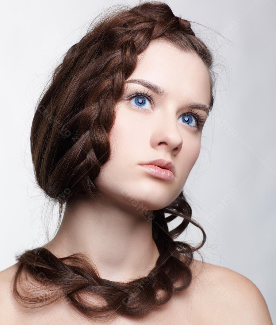 Mulher com trança elaborada e olhos azuis