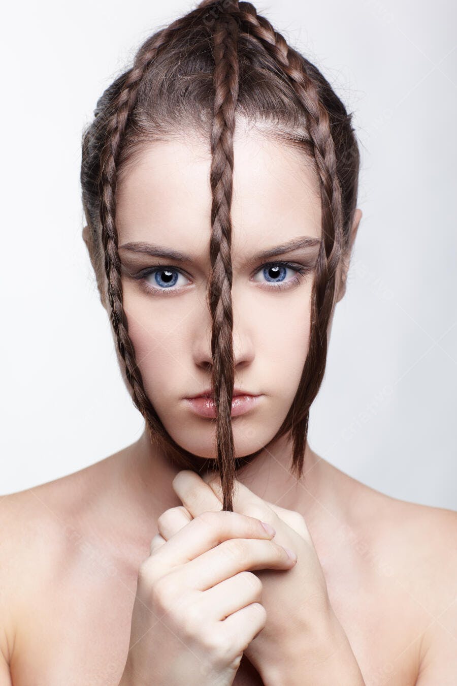 Mulher com tranças elaboradas e olhos azuis