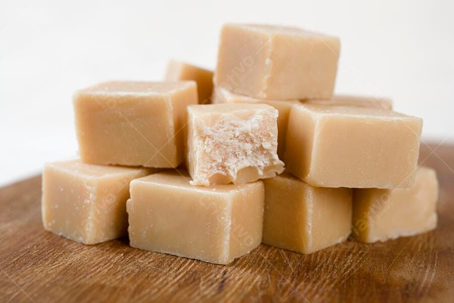 Fudge cremoso em cubos sobre madeira