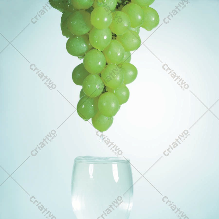 Uvas verdes pingando em copo d'água