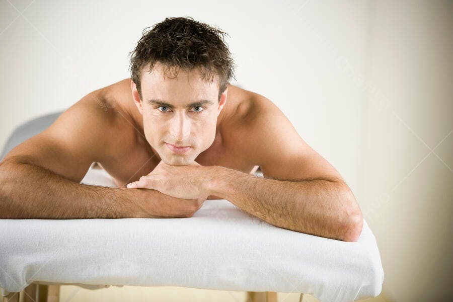 Homem relaxado em mesa de massagem