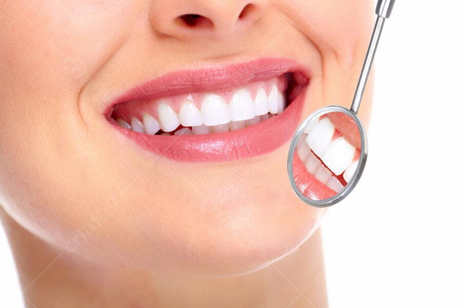 Sorriso saudável com dentes brancos e espelho dental