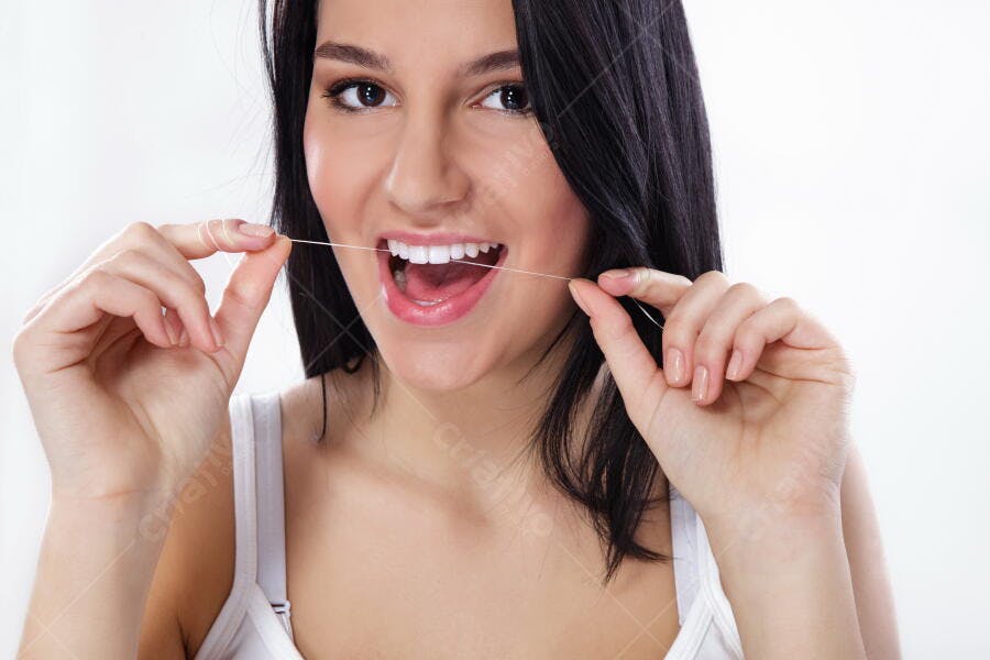 Mulher usando fio dental sorriso saudável