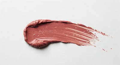 Traço de tinta metálica ouro rosa em superfície branca