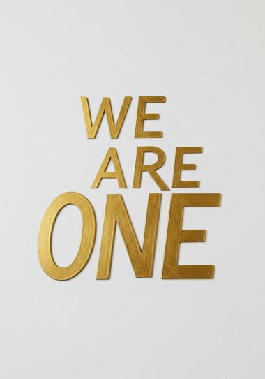 Photography of gold letters spelling out We Are One against a white backdrop. The letters are large and bold, with a metallic finish. The image has a simple, minimalist composition, conveying a message of unity.
