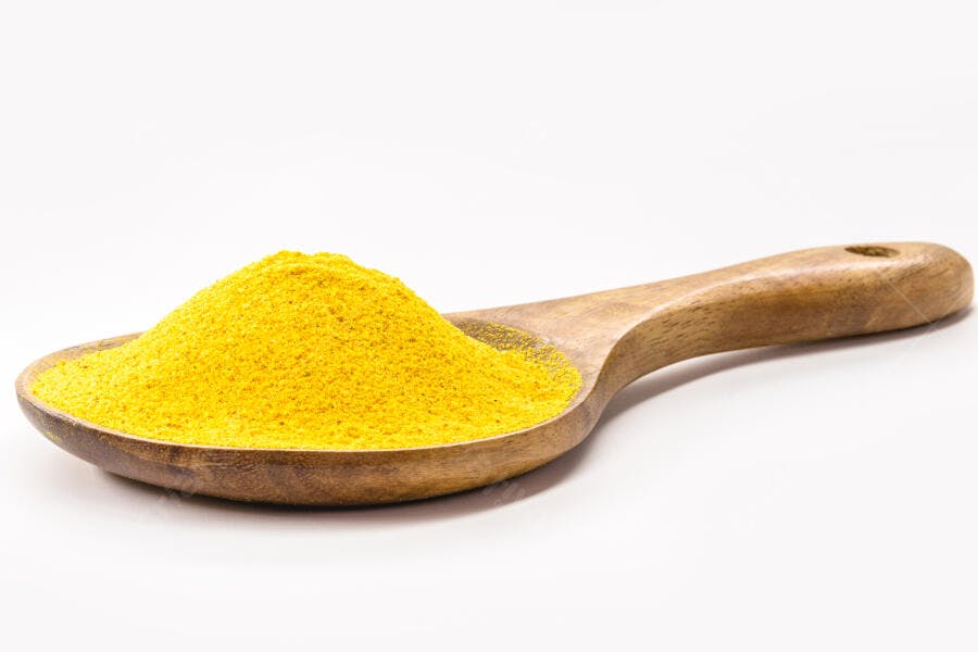 Cúrcuma pó amarelo em colher de madeira para culinária e saúde