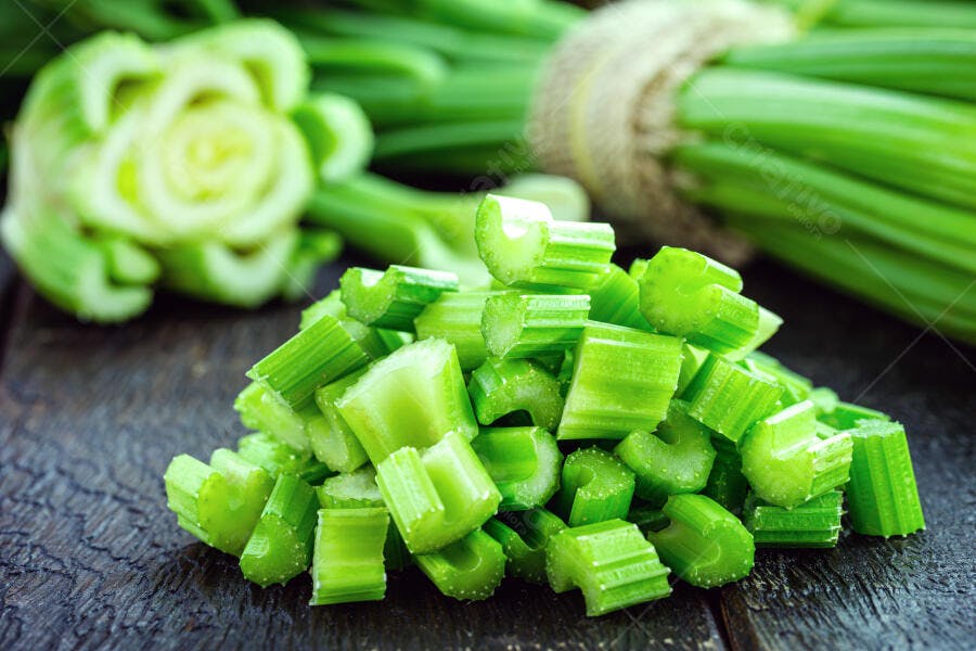 Aipo picado verde vibrante pronto para cozinhar sobre madeira escura