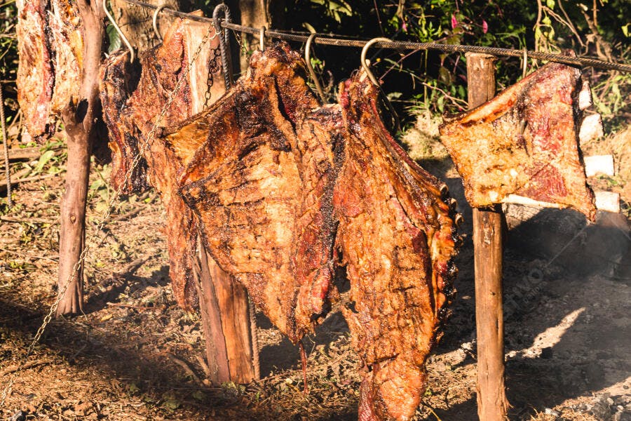 Costelão assando em churrasco fogo de chão ao ar livre