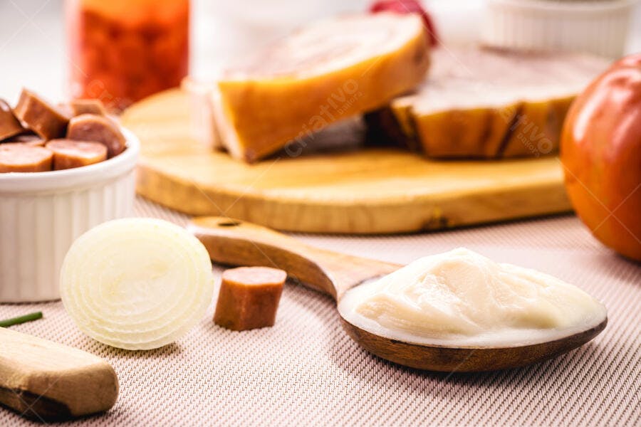 Cebola descascada maionese e salsicha para preparação de refeição na cozinha