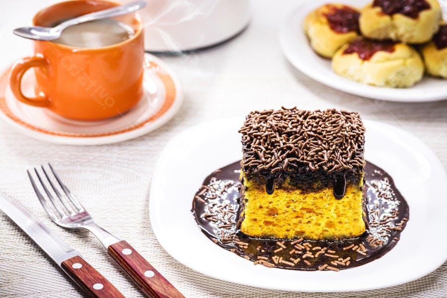 Bolo de cenoura com cobertura de chocolate e granulado para café da manhã