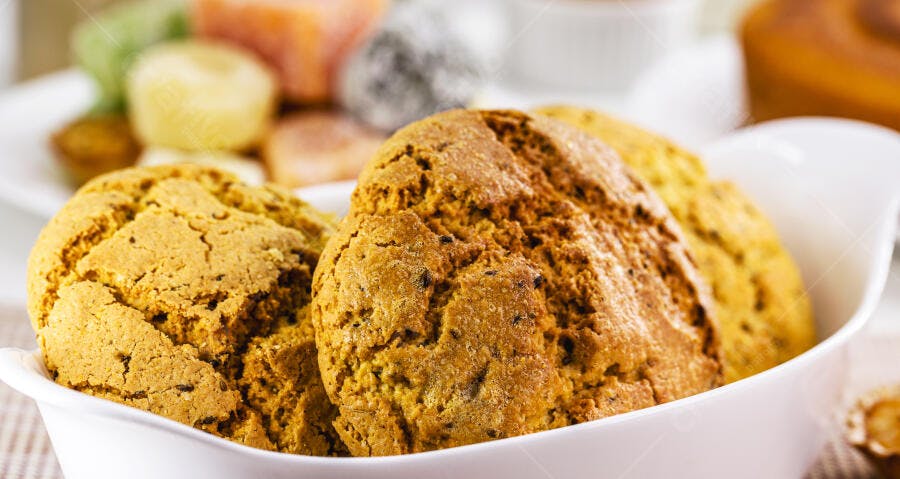 Biscoitos dourados com textura rústica em tigela branca para o café da tarde