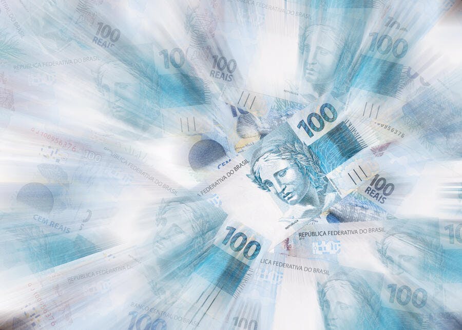 Cédulas de 100 Reais brasileiras em movimento rápido abstrato azul claro