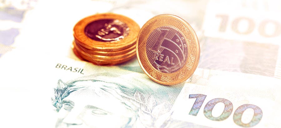 Moedas de 1 Real brasileiras e cédula de 100 reais dinheiro e economia