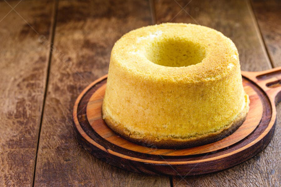 Bolo de fubá amarelo caseiro em tábua de madeira rústica
