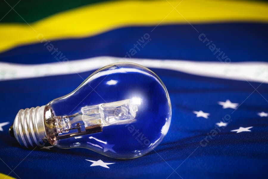 Lâmpada incandescente de vidro transparente sobre a bandeira do Brasil