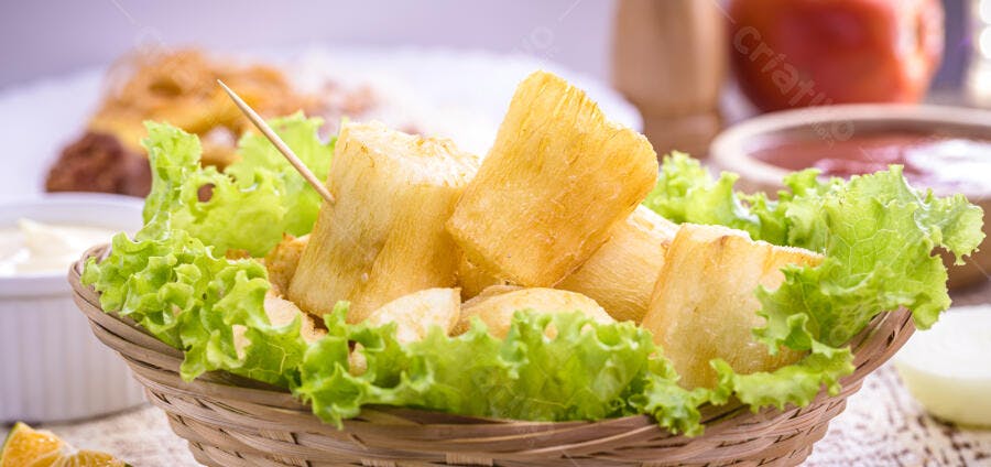 Mandioca frita crocante em cesta com alface e molhos