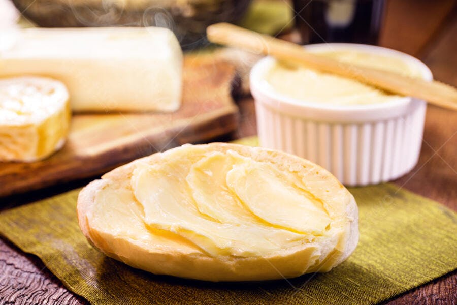 Pão francês quente com manteiga derretida e vapor para café da manhã caseiro