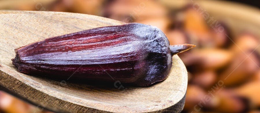 Pinhão roxo escuro em colher de madeira rústica alimento natural