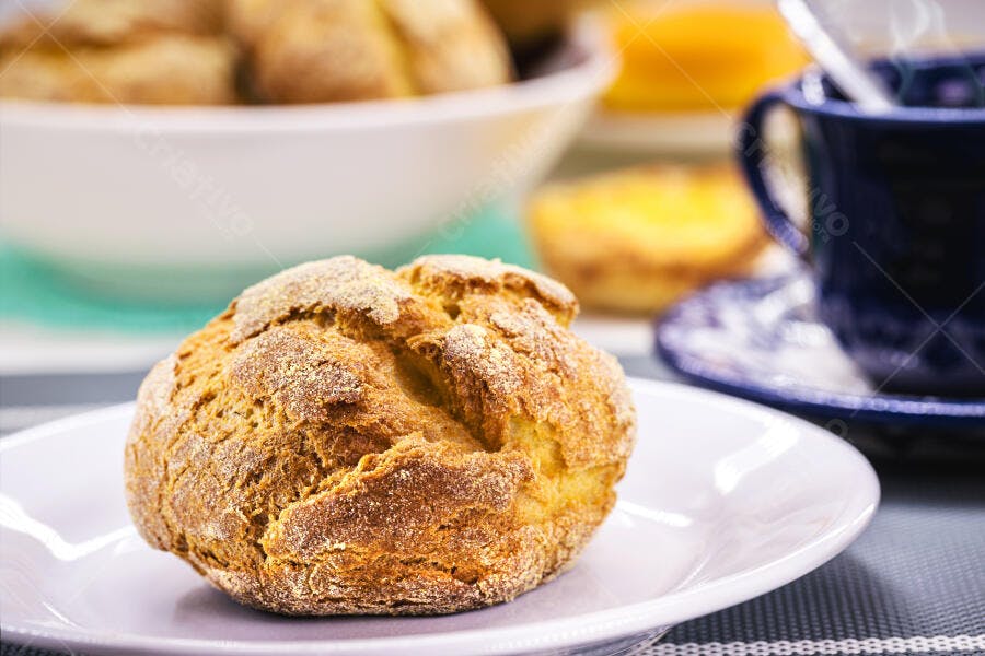 Pão de milho rústico dourado em prato branco com café da manhã