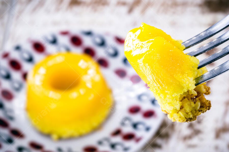 Pudim cremoso amarelo com garfo servindo sobremesa doce