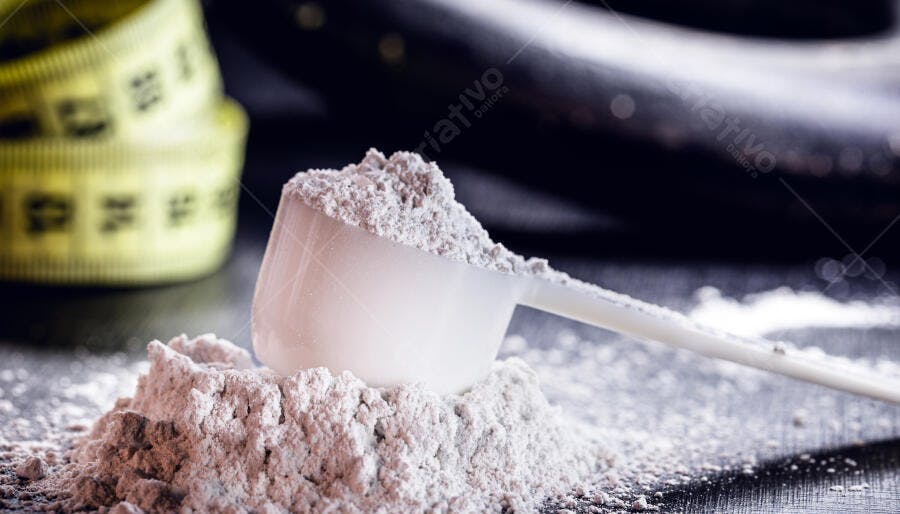 Pó de proteína branco em colher medidora com fita métrica