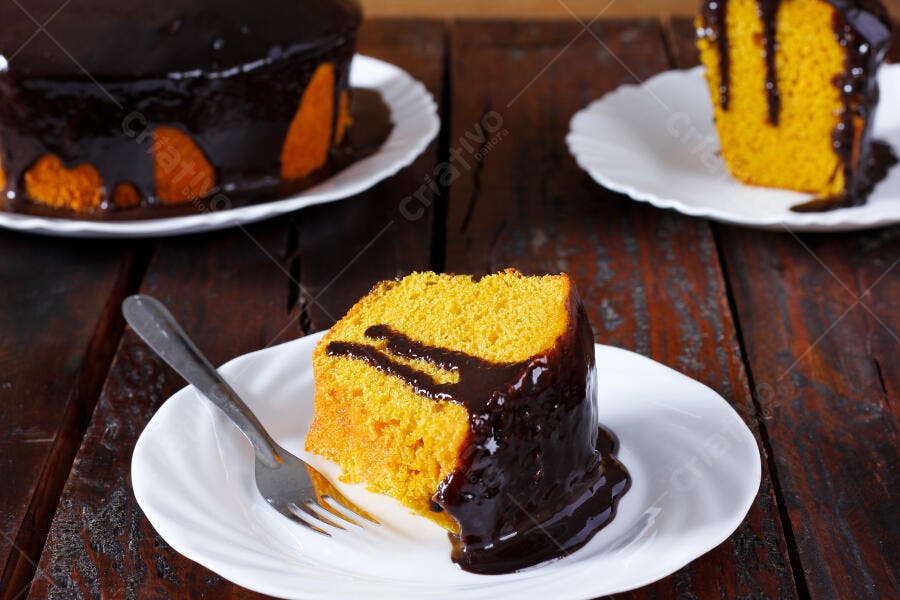 Bolo de cenoura com calda de chocolate em mesa rústica de madeira