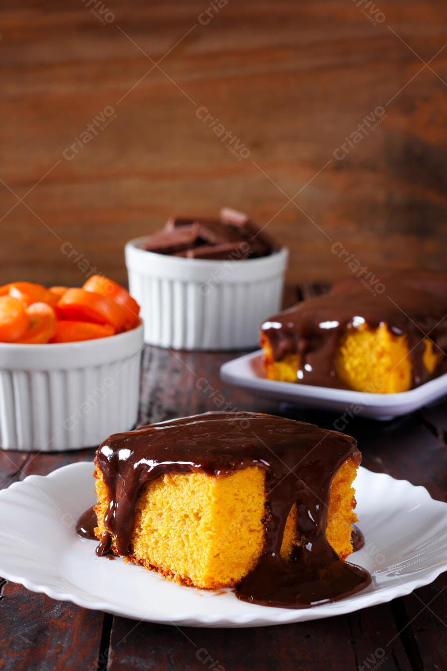 Bolo de cenoura com cobertura de chocolate em mesa rústica